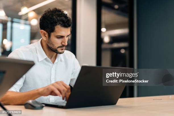 professional software developer working late at night writing codes in an office. - data scientist stock pictures, royalty-free photos & images