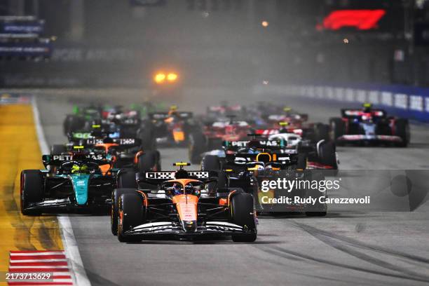 Lando Norris of Great Britain driving the McLaren MCL38 Mercedes leads Max Verstappen of the Netherlands driving the Oracle Red Bull Racing RB20 and...
