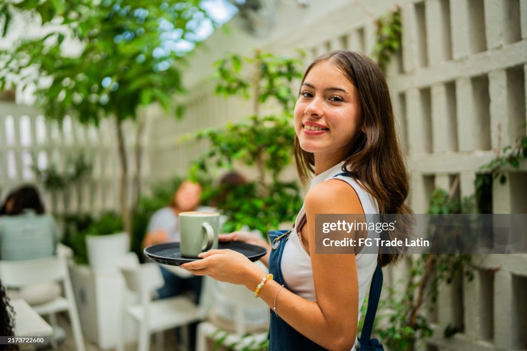 Portrait of a waitress working at coffee shop