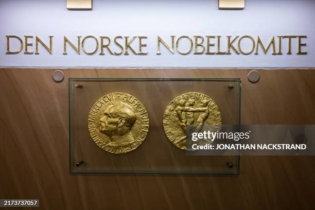 Photo taken on September 25, 2024 in Oslo, Norway shows replicas of the obverse and reverse of the Nobel Peace Prize medal displayed at The Norwegian...
