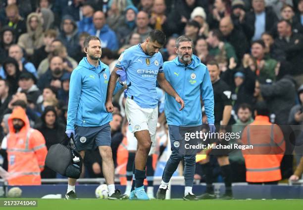 Rodri of Manchester City leaves the pitch following an injury during the Premier League match between Manchester City FC and Arsenal FC at Etihad...