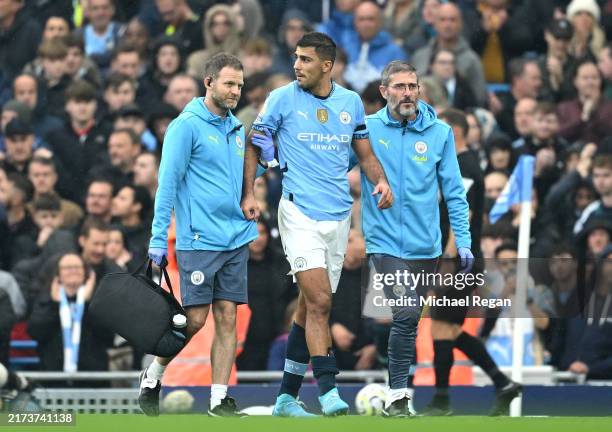 Rodri of Manchester City leaves the pitch following an injury during the Premier League match between Manchester City FC and Arsenal FC at Etihad...