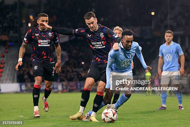 Glasgow Rangers' Welsh midfielder Tom Lawrence tackles Malmoe's Swedish midfielder Taha Ali during the UEFA Europa League football match between...