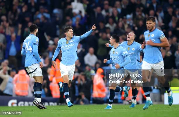 John Stones of Manchester City celebrates scoring his team's second goal with teammates during the Premier League match between Manchester City FC...