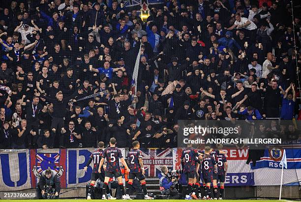 Rangers' players celebrate with supporters at the end of the UEFA Europa League football match between Malmoe FF and Rangers FC in Malmoe, Sweden on...