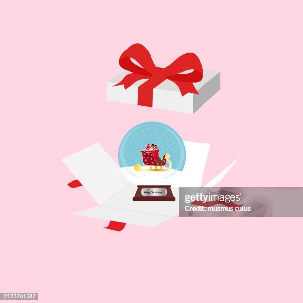 a snow globe emerges from an opened gift box - opened christmas box stock illustrations