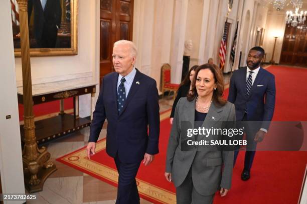 President Joe Biden and US Vice President Kamala Harris walk to an event on gun violence in the East Room of the White House in Washington, DC on...