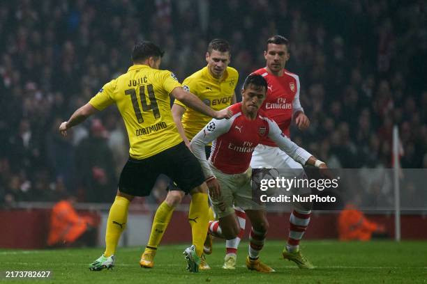 Alexis Sanchez of Arsenal competes for the ball with Milos Jojic of Borussia Dortmund during the UEFA Champions League Group D soccer match between...