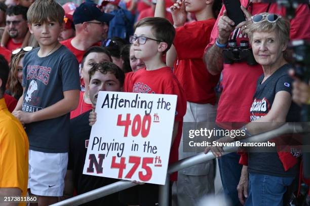Young fan awaits the arrival of the team before the game between the Nebraska Cornhuskers and the Illinois Fighting Illini at Memorial Stadium on...