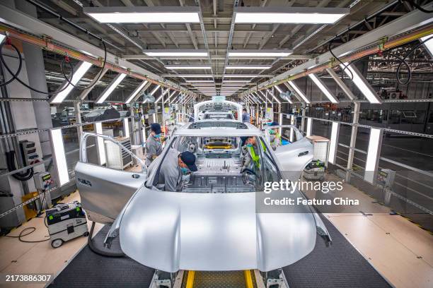 People work at a new production base of Volkswagen Anhui in Hefei city in central China's Anhui province.