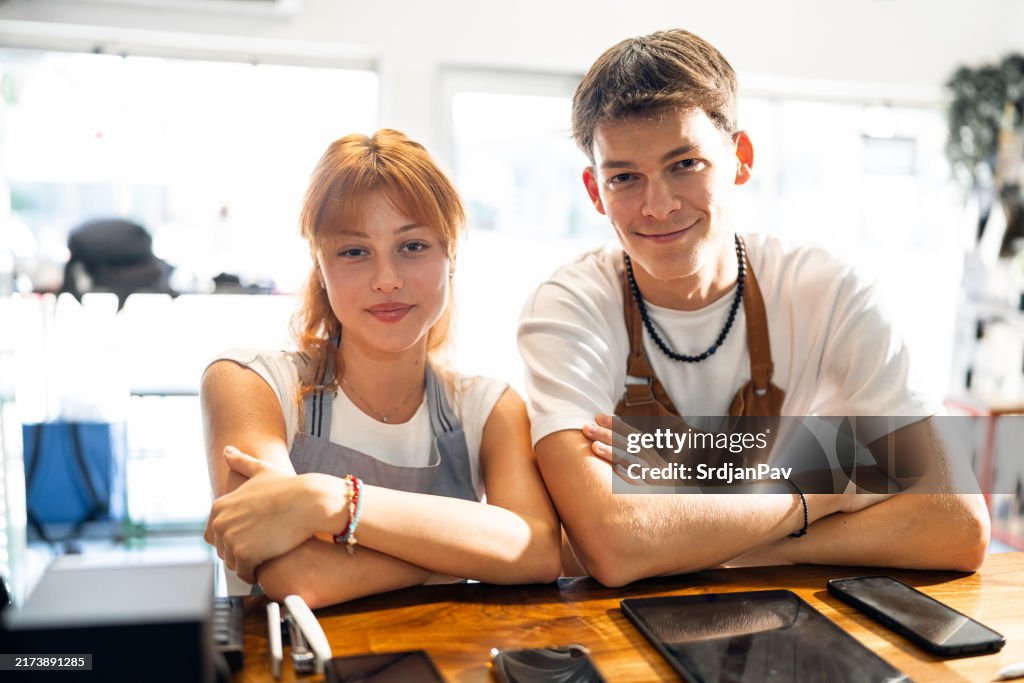 Porträt einer kaukasischen Frau und eines männlichen Teenagers, die in einem modernen Café arbeiten