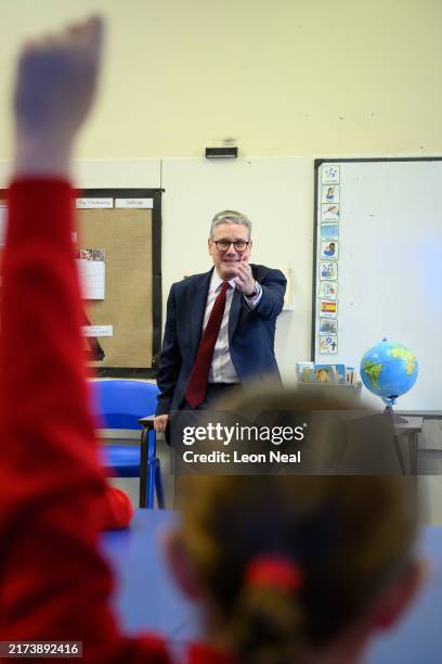 Britain's Prime Minister Keir Starmer speaks with pupils at Holy Cross Catholic Primary School during a visit on September 23, 2024 in Liverpool,...