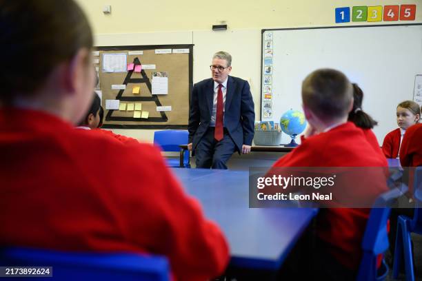 Britain's Prime Minister Keir Starmer speaks with pupils at Holy Cross Catholic Primary School during a visit on September 23, 2024 in Liverpool,...