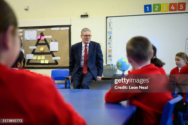 Britain's Prime Minister Keir Starmer speaks with pupils at Holy Cross Catholic Primary School during a visit on September 23, 2024 in Liverpool,...