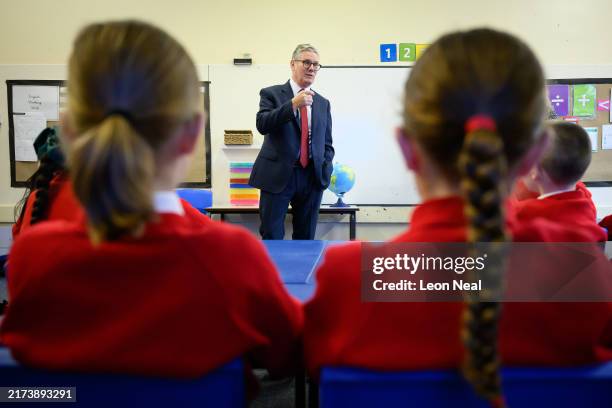 Britain's Prime Minister Keir Starmer speaks with pupils at Holy Cross Catholic Primary School during a visit on September 23, 2024 in Liverpool,...