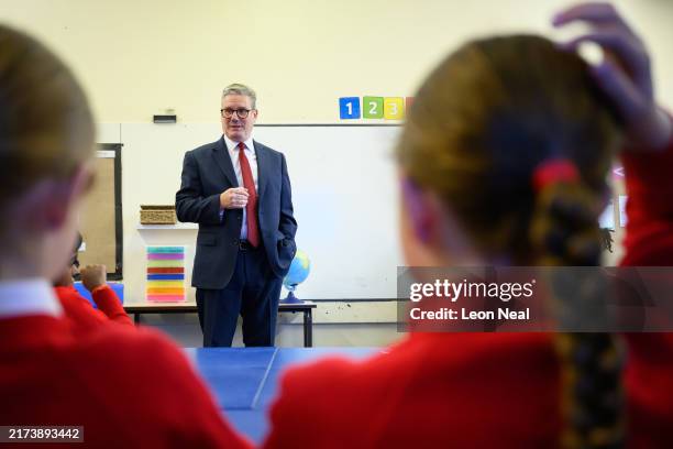 Britain's Prime Minister Keir Starmer speaks with pupils at Holy Cross Catholic Primary School during a visit on September 23, 2024 in Liverpool,...