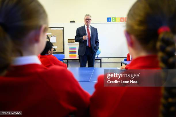 Britain's Prime Minister Keir Starmer speaks with pupils at Holy Cross Catholic Primary School during a visit on September 23, 2024 in Liverpool,...