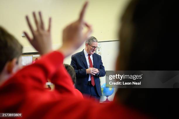 Britain's Prime Minister Keir Starmer speaks with pupils at Holy Cross Catholic Primary School during a visit on September 23, 2024 in Liverpool,...