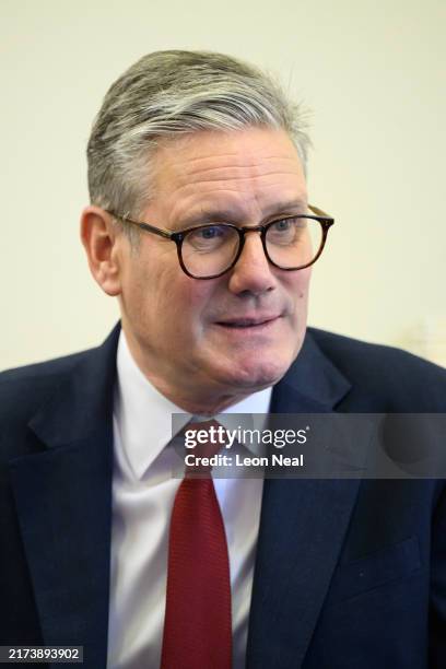 Britain's Prime Minister Keir Starmer speaks with pupils at Holy Cross Catholic Primary School during a visit on September 23, 2024 in Liverpool,...