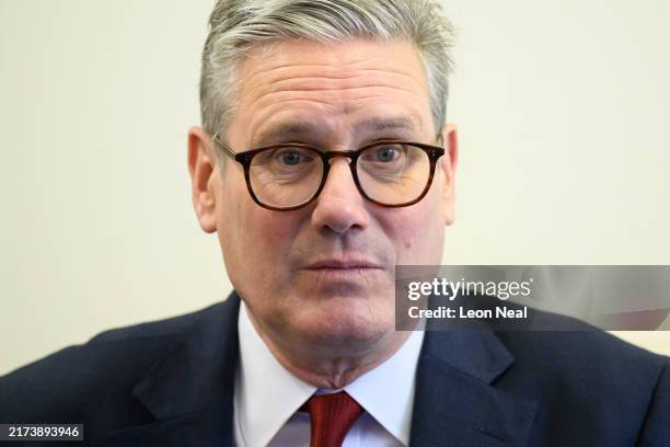 Britain's Prime Minister Keir Starmer speaks with pupils at Holy Cross Catholic Primary School during a visit on September 23, 2024 in Liverpool,...