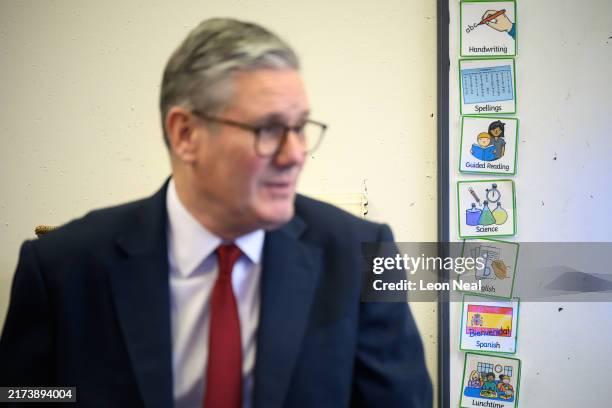Britain's Prime Minister Keir Starmer speaks with pupils at Holy Cross Catholic Primary School during a visit on September 23, 2024 in Liverpool,...