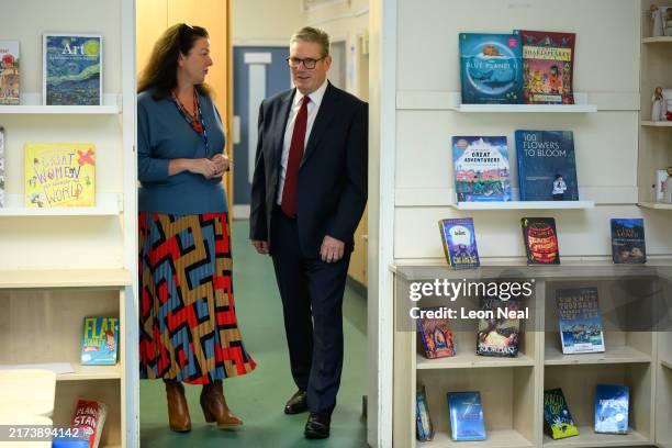 Britain's Prime Minister Keir Starmer speaks with headteacher Helen Bannon at Holy Cross Catholic Primary School during a visit on September 23, 2024...