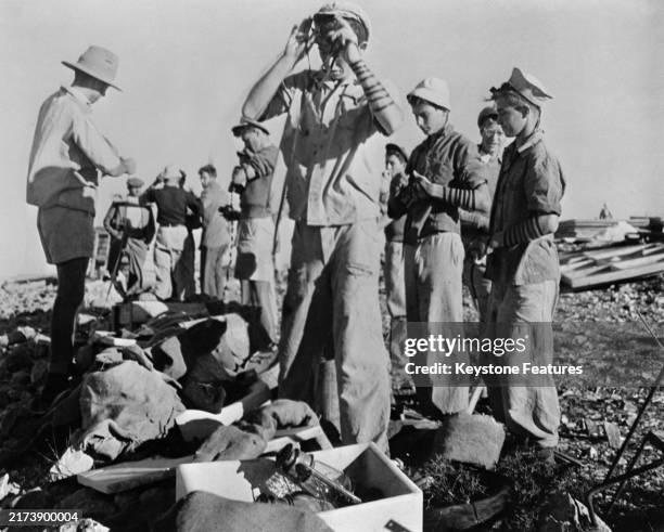 Young Jewish men say their morning prayers at a new settlement in Palestine, circa November 1946. The men were taking a break from constructing...