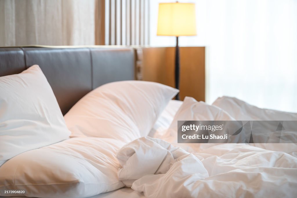 Comfortable bed in modern hotel.