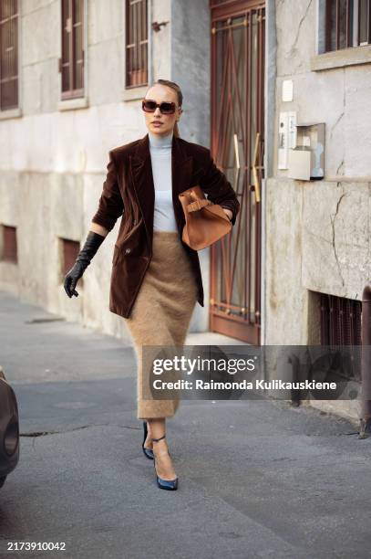 Viky Rader wears dark brown sunglasses, light blue turtle neck, dark brown velvet blazer jacket, light brown fluffy midi skirt, brown leather bag,...