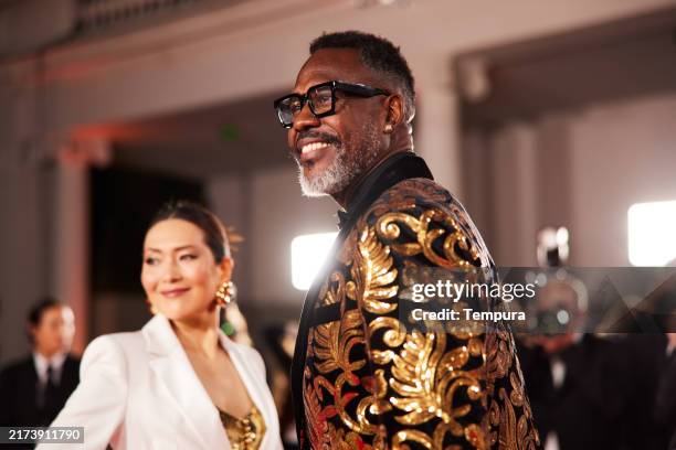 the leading actor and actress from the cast stand confidently, posing for the paparazzi as flashes light up the red carpet. - film premiere stock pictures, royalty-free photos & images