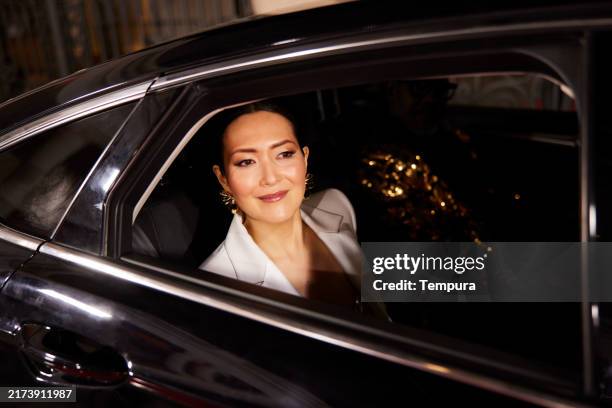 the actress gazes at the crowd through the limousine window at the event's arrival. - överklass bildbanksfoton och bilder