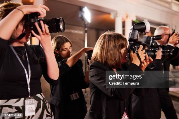 in the press area, photographers rush to take photos of the event. - photographer stock pictures, royalty-free photos & images
