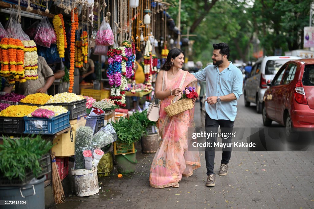 Indian mid-adult couple strolling through a local flower market in Mumbai