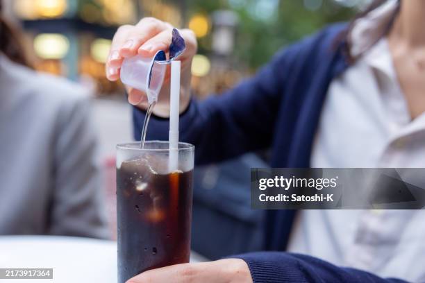 woman pouring syrup in outdoor cafe - tokyo street food stock pictures, royalty-free photos & images