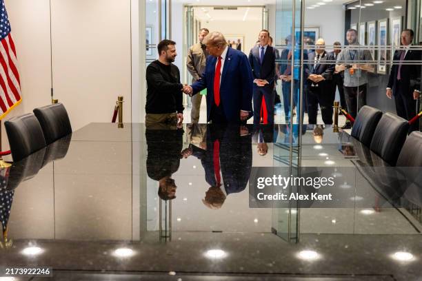Ukrainian President Volodymyr Zelensky and Republican presidential nominee, former U.S. President Donald Trump, shake hands during a meeting on...