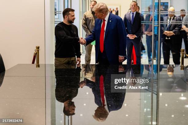 Ukrainian President Volodymyr Zelensky and Republican presidential nominee, former U.S. President Donald Trump, shake hands during a meeting on...