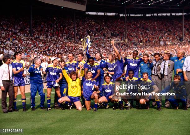 Wimbledon players line up for a group photo as they celebrate with the trophy after the FA Cup final between Liverpool and Wimbledon at Wembley...