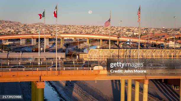 From an aerial view the Mexican and American flags fly over the Rio Grande at the U.S.-Mexico border on September 18, 2024 in El Paso, Texas....