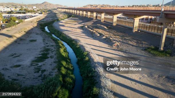 From an aerial view Texas National Guard troops inspect razor wire lining the Rio Grande at the U.S.-Mexico border on September 18, 2024 in El Paso,...