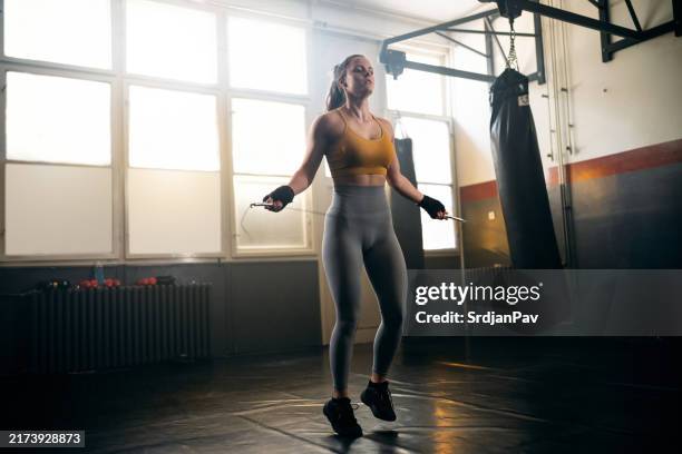 female athlete exercise in the gym with a jumping rope - skipping rope stock pictures, royalty-free photos & images