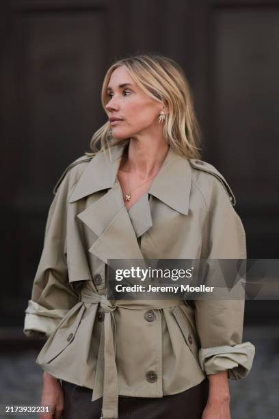 Jennifer Zimmermann is seen wearing gold and diamond shooting star-shaped earrings from Ole Lynggaard; a fine yellow gold necklace with a yellow gold...