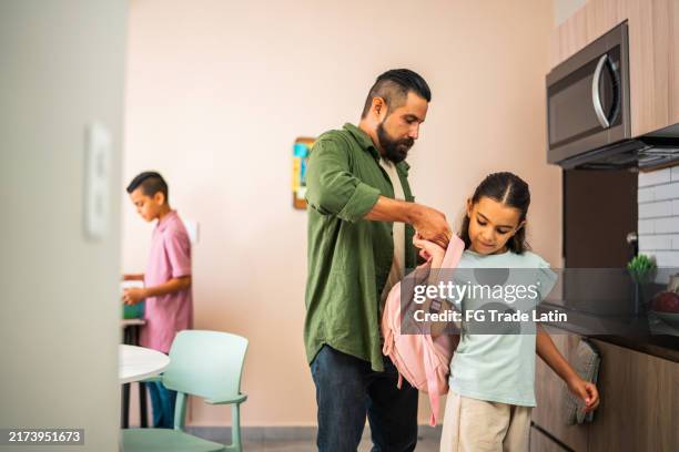 daughter and father preparing bag for first day of school at home - back to school stock pictures, royalty-free photos & images