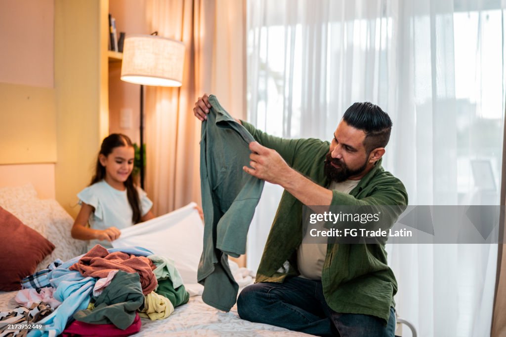 Father organizing clothes at home