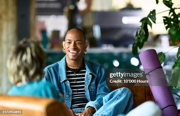 non binary business person receiving positive feedback from colleague - nonbinary stock pictures, royalty-free photos & images
