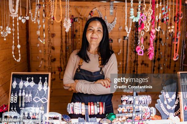 mature woman behind the jewelry stall - vendor stock pictures, royalty-free photos & images