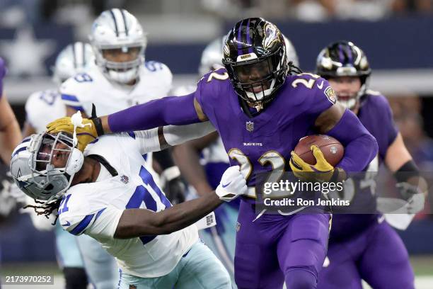 Derrick Henry of the Baltimore Ravens rushes for a first down against Caelen Carson of the Dallas Cowboys during the third quarter at AT&T Stadium on...