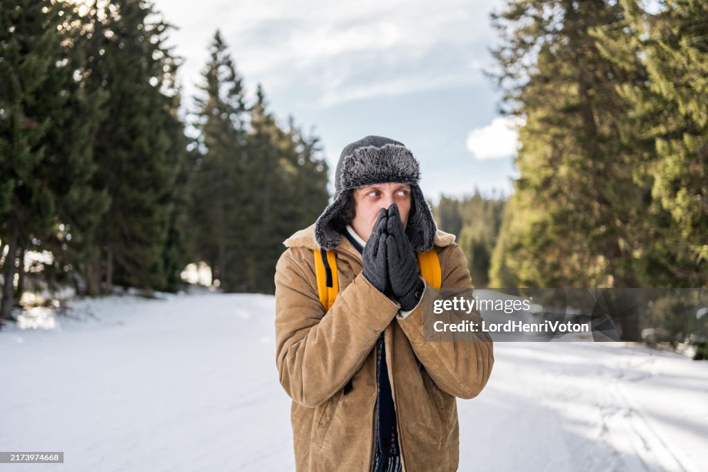 Young man is freezing on a cold winter