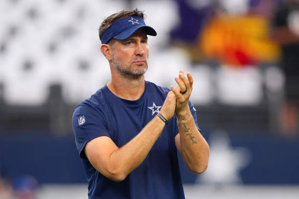 Dallas Cowboys offensive coordinator Brian Schottenheimer watches his team warm up before the game against the Baltimore Ravens at AT&T Stadium on...