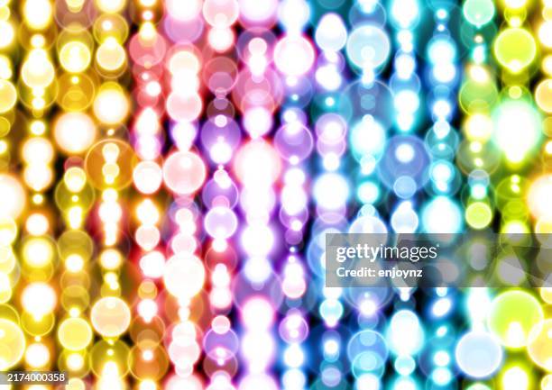 seamless vertical lines of rainbow christmas lights background - string lights black background stock illustrations