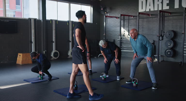 https://media.gettyimages.com/id/2174000444/video/coach-group-and-kettlebell-in-gym-for-fitness-with-senior-people-with-muscle-development-in.jpg?b=1&s=640x640&k=20&c=xr2zpy9FsR2zKsXdUBi9KjXGQTwltMhayWrW9FesQZ0=
